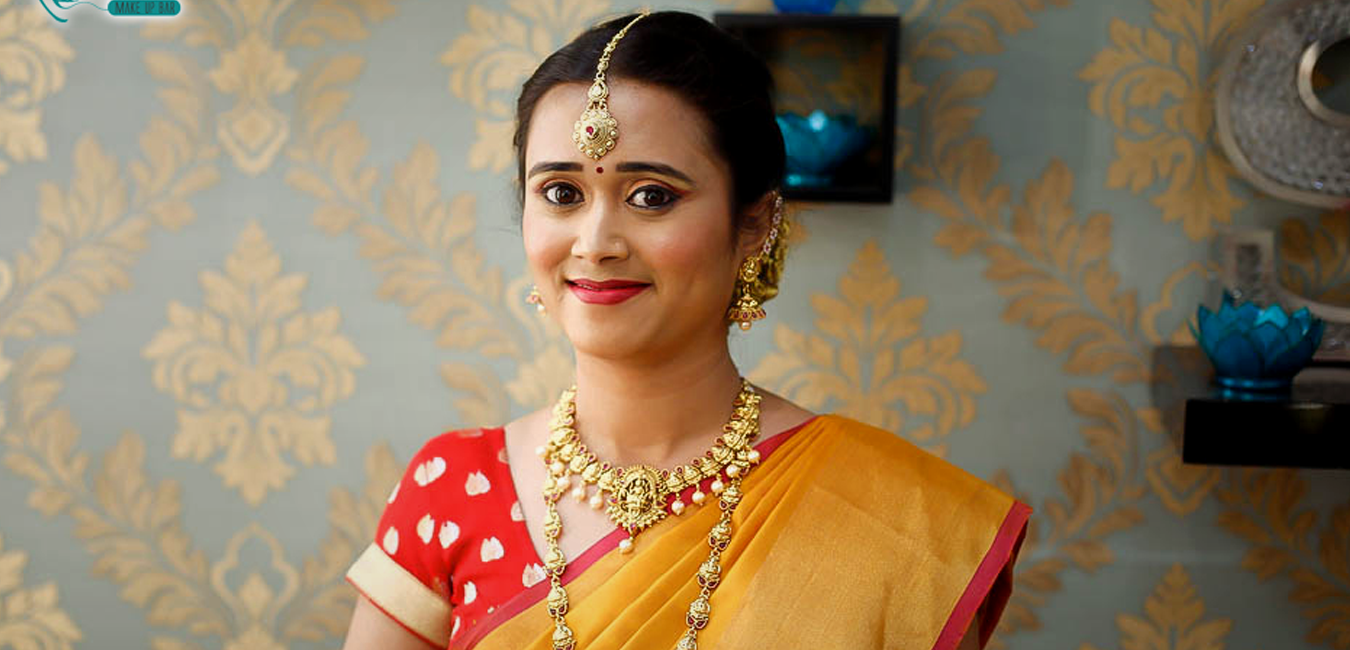 Portrait of a traditional south Indian bride in yellow saree with wedding makeup