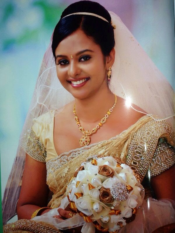smiling bride with wedding veil holding bouquet on her wedding ceremony