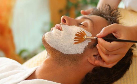 Makeup artist applying facial to a groom for his wedding ceremony