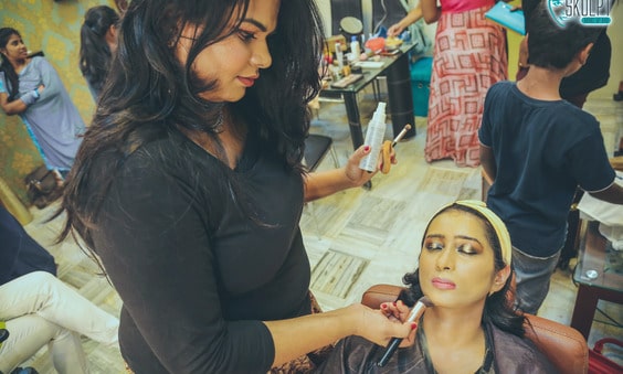 makeup artist applying makeup to a client 