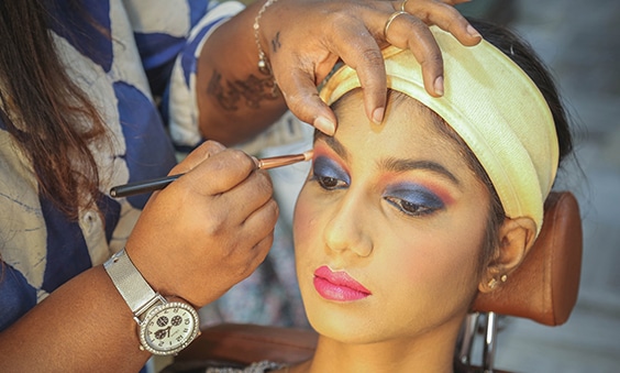 Skulpt Makeup Artist applying eye liner with makeup brush to a woman